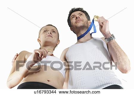 Low angle view of couple wearing medals View Large Photo Image Picture - Low angle view of couple wearing medals. Fotosearch