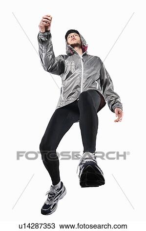 Stock Image - Low angle view of man jogging. Fotosearch