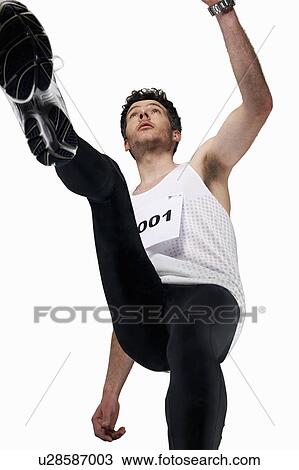 Low angle view of man jogging View Large Photo Image Stock Image - Low angle view of man jogging. Fotosearch