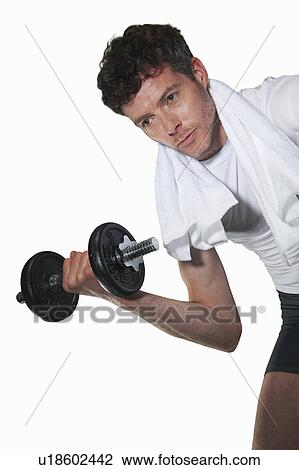 Stock Image - Low angle view of man lifting weights. Fotosearch