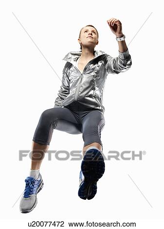 Low angle view of woman jogging View Large Photo Image Stock Image - Low angle view of woman jogging. Fotosearch