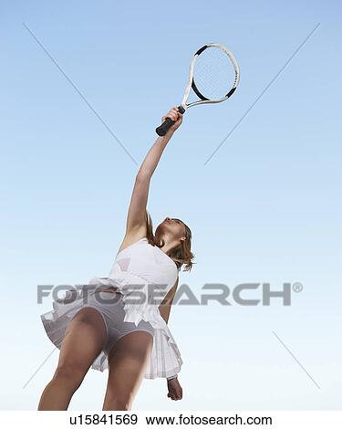 Low angle view of woman playing tennis View Large Photo Image Stock Photo - Low angle view of woman playing tennis. Fotosearch