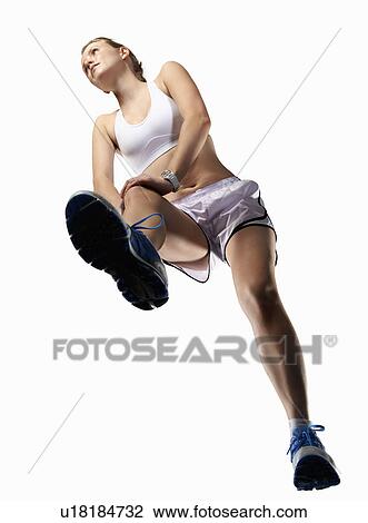 Low angle view of woman stretching View Large Photo Image Stock Image - Low angle view of woman stretching. Fotosearch