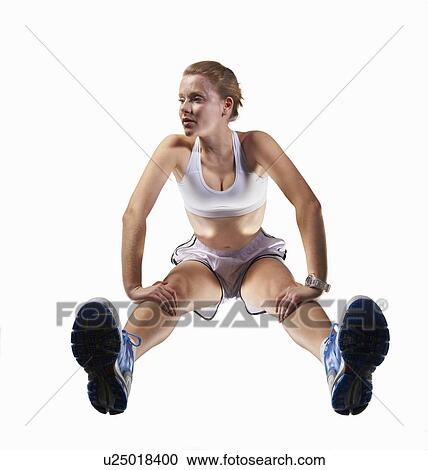 Low angle view of woman stretching View Large Photo Image Stock Image - Low angle view of woman stretching. Fotosearch