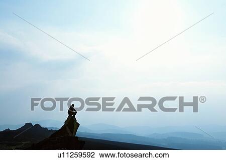 Stock Image - Man admiring mountain view. Fotosearch