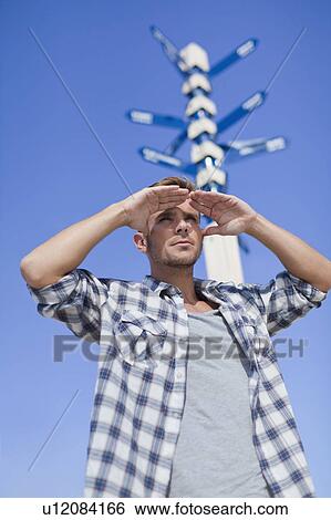 Man admiring view at crossroads View Large Photo Image Stock Photograph - Man admiring view at crossroads. Fotosearch