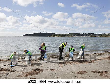 Picture - Man and children cleaning beach. Fotosearch