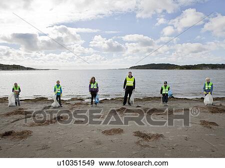 Stock Photo - Man and children cleaning beach. Fotosearch