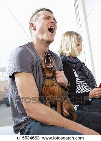 Stock Image - Man and dog howling together. Fotosearch