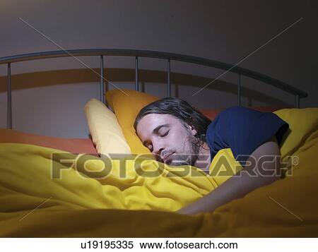 Man asleep in bed View Large Photo Image Stock Photography - Man asleep in bed. Fotosearch