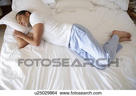 Man asleep on bed View Large Photo Image Picture - Man asleep on bed. Fotosearch