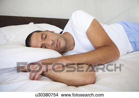Man asleep on bed View Large Photo Image Picture - Man asleep on bed. Fotosearch