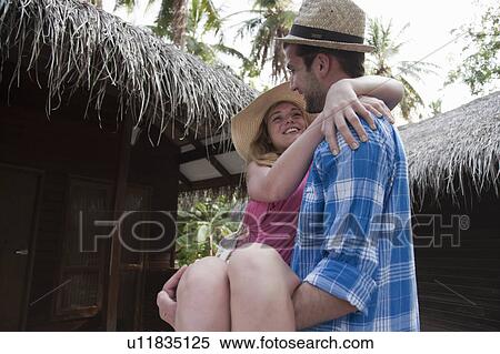 Stock Photography - Man carrying girlfriend over threshold. Fotosearch