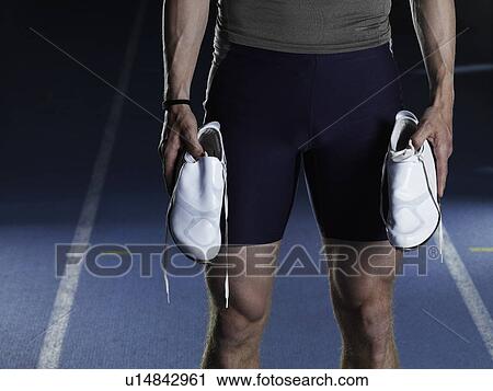 Man carrying running shoes on track View Large Photo Image Stock Image - Man carrying running shoes on track. Fotosearch
