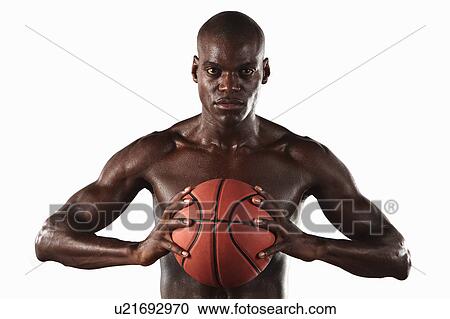 Stock Image - Man clutching basketball. Fotosearch
