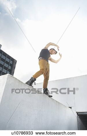 Man dancing on urban rooftop View Large Photo Image Stock Image - Man dancing on urban rooftop. Fotosearch