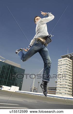 Man dancing on urban rooftop View Large Photo Image Stock Photo - Man dancing on urban rooftop. Fotosearch
