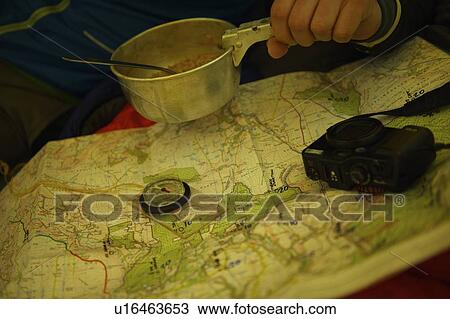 Man eating and examining trail map View Large Photo Image Stock Image - Man eating and examining trail map. Fotosearch