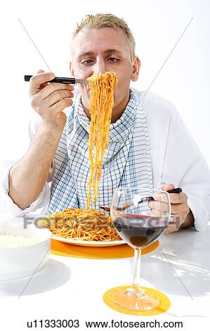 Man eating plate of spaghetti View Large Photo Image Stock Image - Man eating plate of spaghetti. Fotosearch