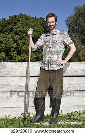 Stock Image - Man gardening outdoors. Fotosearch