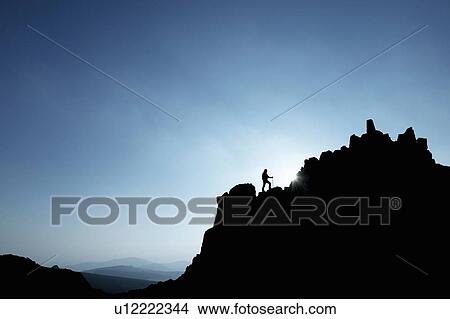 Man hiking on rocky hillside View Large Photo Image Picture - Man hiking on rocky hillside. Fotosearch