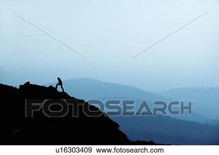 Man hiking on rocky hillside View Large Photo Image Stock Photo - Man hiking on rocky hillside. Fotosearch