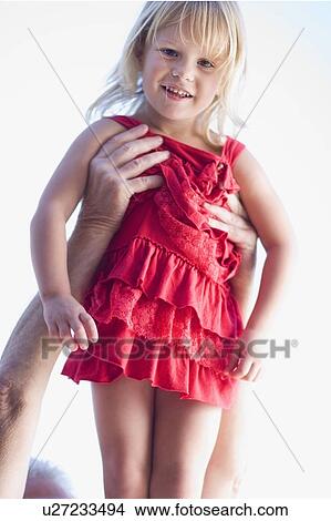 Man holding young girl in the air View Large Photo Image Picture - Man holding young girl in the air. Fotosearch