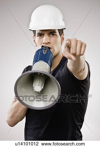 Man in hard hat using megaphone View Large Photo Image Stock Image - Man in hard hat using megaphone. Fotosearch
