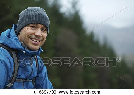Stock Photo - Man in hiking gear on hillside. Fotosearch