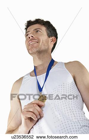 Stock Image - Man in running gear wearing medal. Fotosearch