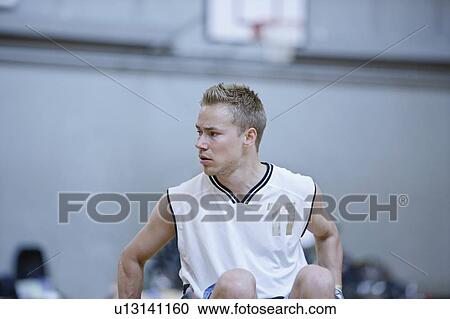 Stock Image - Man in wheelchair playing indoor sports. Fotosearch