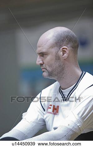 Stock Photo - Man in wheelchair playing indoor sports. Fotosearch