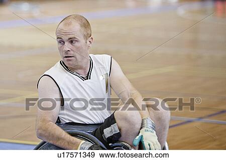 Man in wheelchair playing indoor sports View Large Photo Image Stock Photo - Man in wheelchair playing indoor sports. Fotosearch