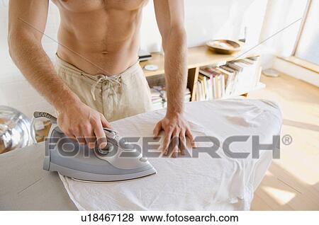Man ironing shirt View Large Photo Image Stock Photo - Man ironing shirt. Fotosearch