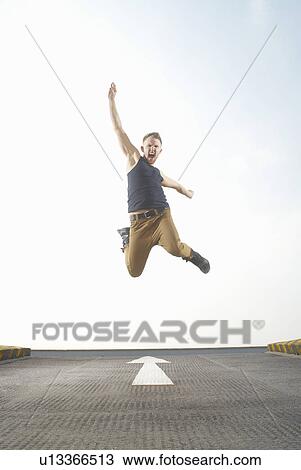 Man jumping in road View Large Photo Image Stock Image - Man jumping in road. Fotosearch