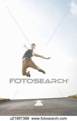 Man jumping in road View Large Photo Image Stock Photo - Man jumping in road. Fotosearch