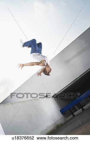 Man jumping on urban rooftop View Large Photo Image Stock Image - Man jumping on urban rooftop. Fotosearch
