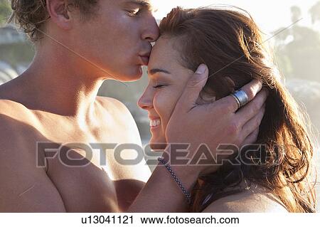 Man kissing woman’s forehead on beach View Large Photo Image Stock Image - Man kissing woman’s forehead on beach. Fotosearch
