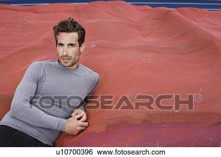 Stock Photograph - Man leaning on mattress. Fotosearch