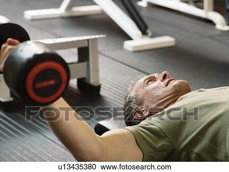 Man lifting weights at gym View Large Photo Image Stock Image - Man lifting weights at gym. Fotosearch