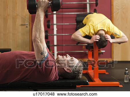 Man lifting weights at gym View Large Photo Image Stock Photo - Man lifting weights at gym. Fotosearch