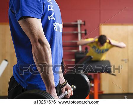 Man lifting weights at gym View Large Photo Image Stock Photograph - Man lifting weights at gym. Fotosearch