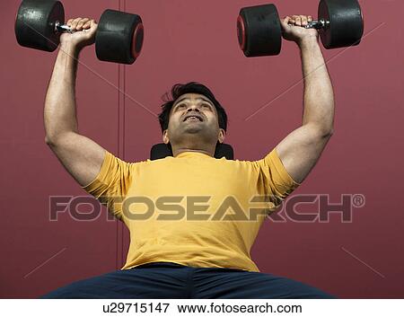 Man lifting weights in gym View Large Photo Image Stock Photo - Man lifting weights in gym. Fotosearch