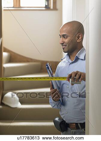 Man measuring hallway View Large Photo Image Stock Image - Man measuring hallway. Fotosearch