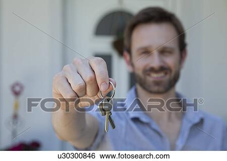 Stock Photograph - Man offering set of keys. Fotosearch