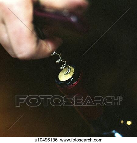 Stock Photograph - Man opening bottle of wine. Fotosearch