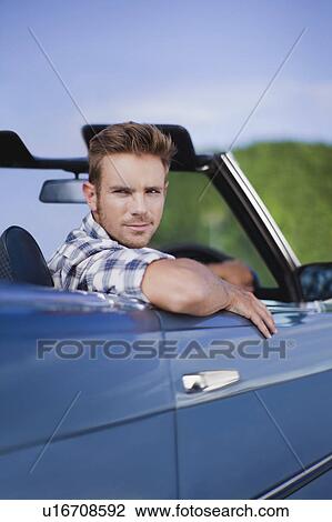Man peering out of convertible View Large Photo Image Stock Image - Man peering out of convertible. Fotosearch