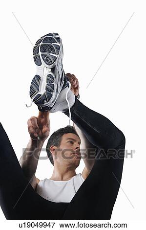 Stock Photo - Man putting on running shoes. Fotosearch