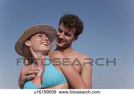 Man putting sunscreen on girlfriend View Large Photo Image Stock Photo - Man putting sunscreen on girlfriend. Fotosearch