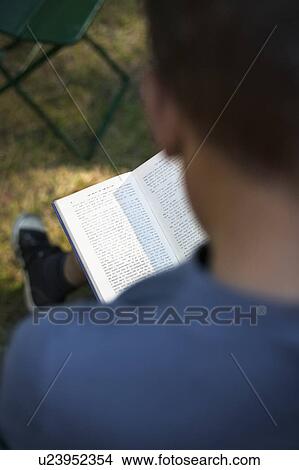 Man reading book outdoors View Large Photo Image Picture - Man reading book outdoors. Fotosearch